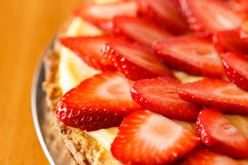 Delicious strawberry tart on table