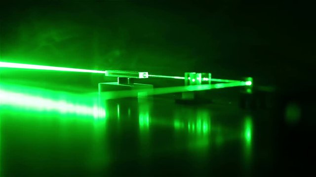 Continuous wave green laser propagates through the optical components. Laser Safety.