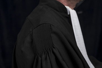 Lawyer in gown with jabot hands close up judge