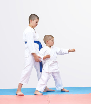 The elder brother karateka is training brother punch arm