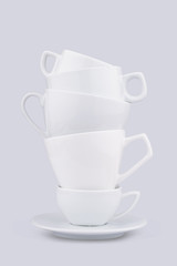 Vertical pile of many white coffee porcelain cups