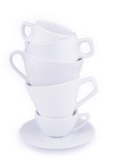 Vertical pile of many white coffee porcelain cups isolated