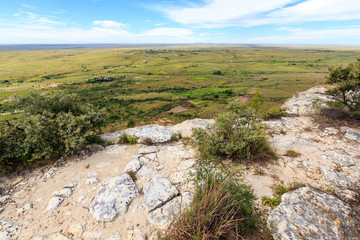 View from a mountain into a green desolate valley