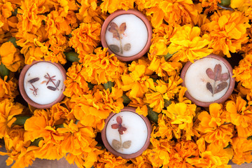 Wax diyas made of clay with marigold flowers for hindu religious celebration and festivity 
