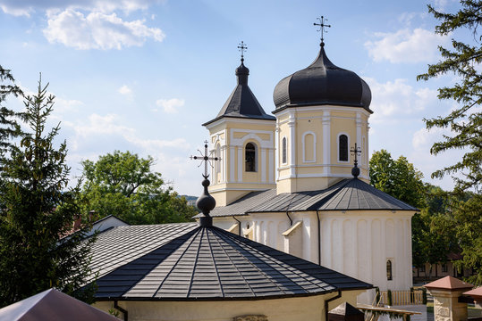 Photo of Capriana Monastery in Moldova with blue sky