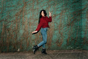 Young beautiful caucasian long brown hair woman dancing outdoor in the city - enjoying, cheerful, happiness concept