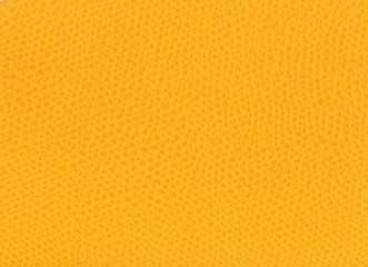 Bright yellow leather background closeup