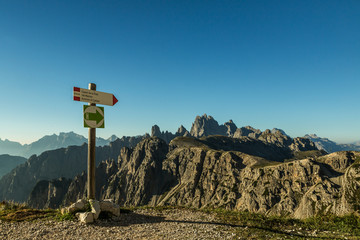 Wooden pointer for hikers in the Dolomites. , Dolomiten mountains, Italien Alps. travel concept. 