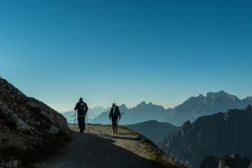 Hiking trail in the Dolomites. Alps, Italy. Hikers walks on a path in 