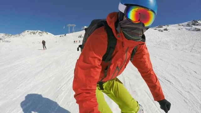 Snowboarding down a ski slope, selfie stick view gimbal stabilized slow motion footage
