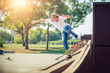 Young man riding skate at park and falling down