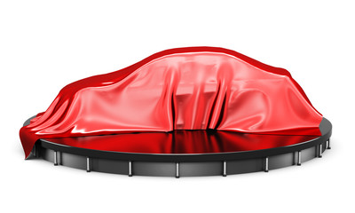Car on the podium covered with a red satin cloth before presenta