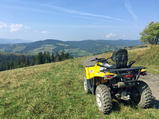 Yellow ATV in the mountains