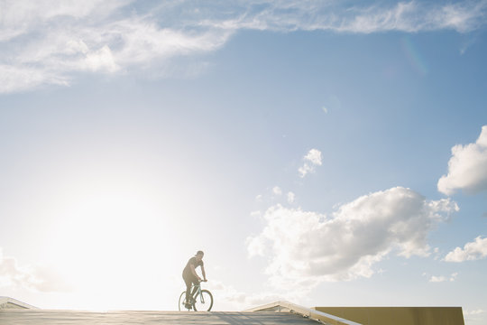 Tricker riding bicycle in sunlight