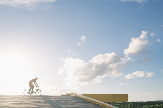 Tricker riding bicycle in sunlight
