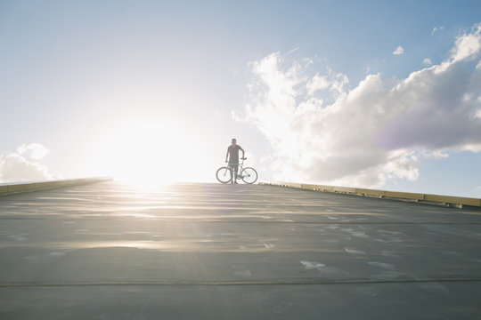 Tricker riding bicycle in sunlight