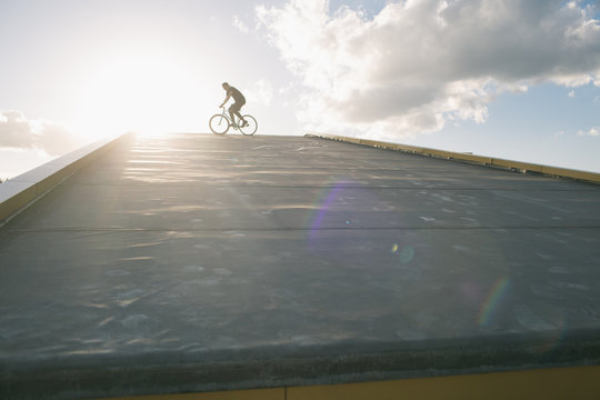 Tricker riding bicycle in sunlight