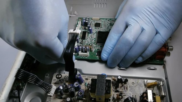 Building Circuit Boards in Electronics Factory. Assembly line of Transistors and other Electronic components being installed