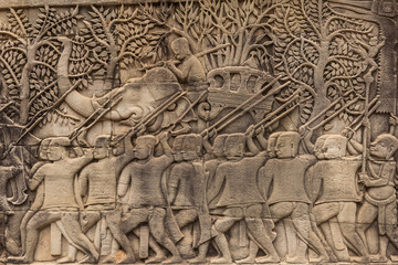 Fototapeta na wymiar Bas-reliefs with war scenes in Bayon temple, Angkor, Cambodia
