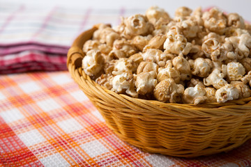 caramel popcorn in a basket on a napkin