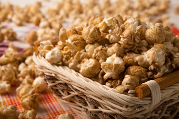 caramel popcorn in a basket on a napkin