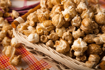 caramel popcorn in a basket on a napkin