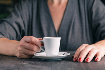 Close up photo of hands and cup of coffee