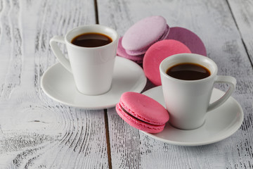 two cups of coffee and macaroons closeup