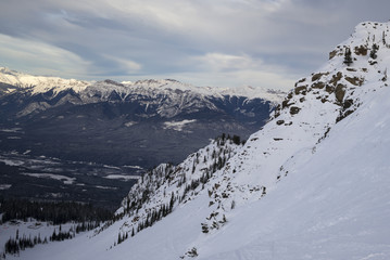 Fototapeta na wymiar Snow covered valley with mountains in winter, Kicking Horse Mou