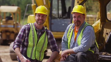 Portrait of two blue collar workers