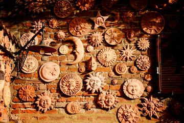 Fototapeta na wymiar handmade collection of terracotta sun decoration