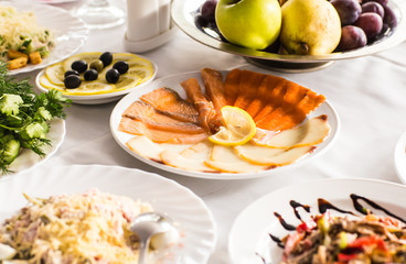 Dish with sliced fish products on the festive table