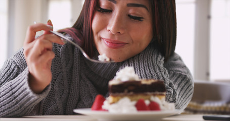 Japanese woman eating cake at home