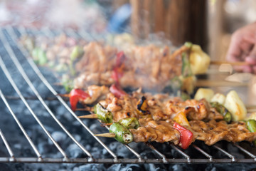 Grilling shashlik on barbecue grill