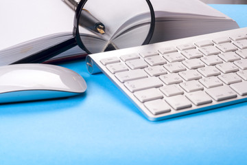 Office black desk table with white computer, business card blank, flower, coffee cup and pen.