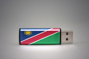 usb flash drive with the national flag of namibia on gray background.