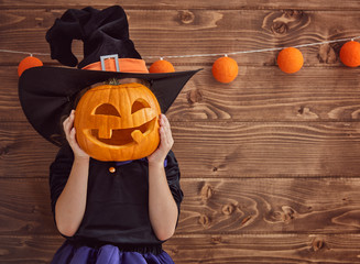 little witch with a pumpkin
