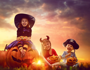 children and pumpkins on Halloween