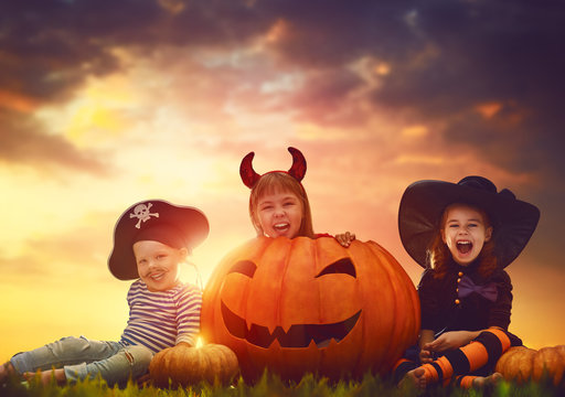 children and pumpkins on Halloween