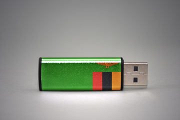 usb flash drive with the national flag of zambia on gray background.
