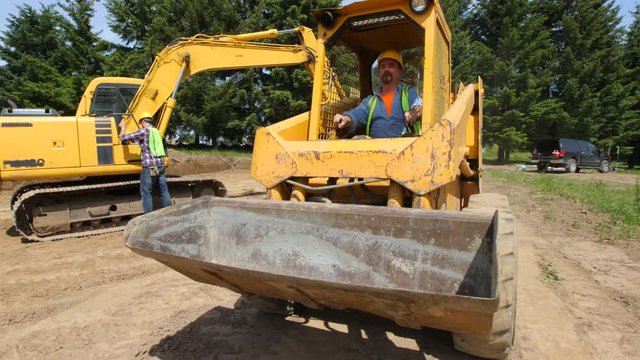 Construction worker driving excavation equipment