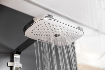 Modern shower with water drops in bath interior