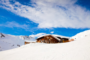 Winter in Alps mountains, Mayerhofen resort. Wooden house under snow