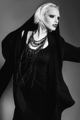 beautiful fashion gothic girl with blond hair, black make up and piercing