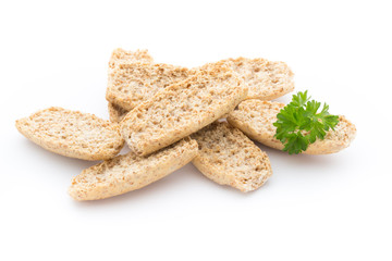 Dry flat bread crisps with herbs on a white background.