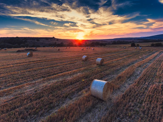 Aerial view on the wheat field with hay bales
