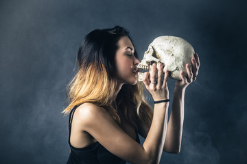 Woman kissing skull