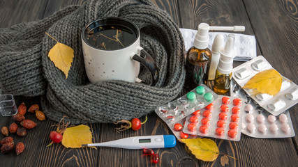 Pills, nose drops and hot tea with lemon for colds, treatment of , flu runny - obrazy, fototapety, plakaty