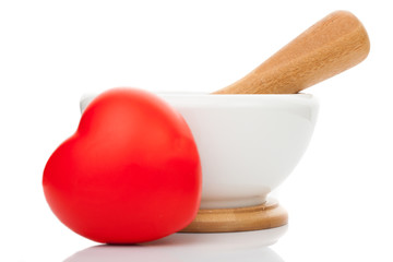 Toy heart in front of mortar and pestle
