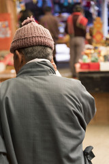 Rear view of a man in traditional clothing at a market in Bhutan.